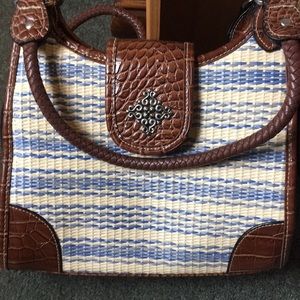 Rosetti purse blue and cream straw-like exterior.